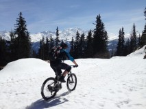 Rik harms is riding over the snow with his mountainbike during a early season bike trip in Verbier
