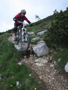 A Mountainbiker is riding rocky trails in the mountains of Lago di Garda in Italy