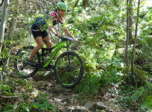 A girl on a Cannondale rides some rocky trails